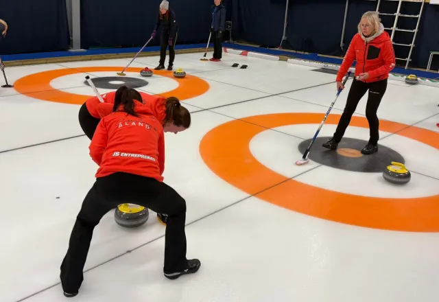 Två sopare och skipp som lägger sten i bo